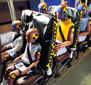 A variety of test dummies are shown aboard a school bus prior to a barrier block crash test at CAPE.