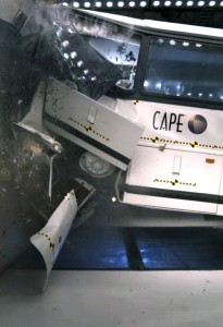 A motorcoach is shown crashing into CAPE's barrier block during a test.