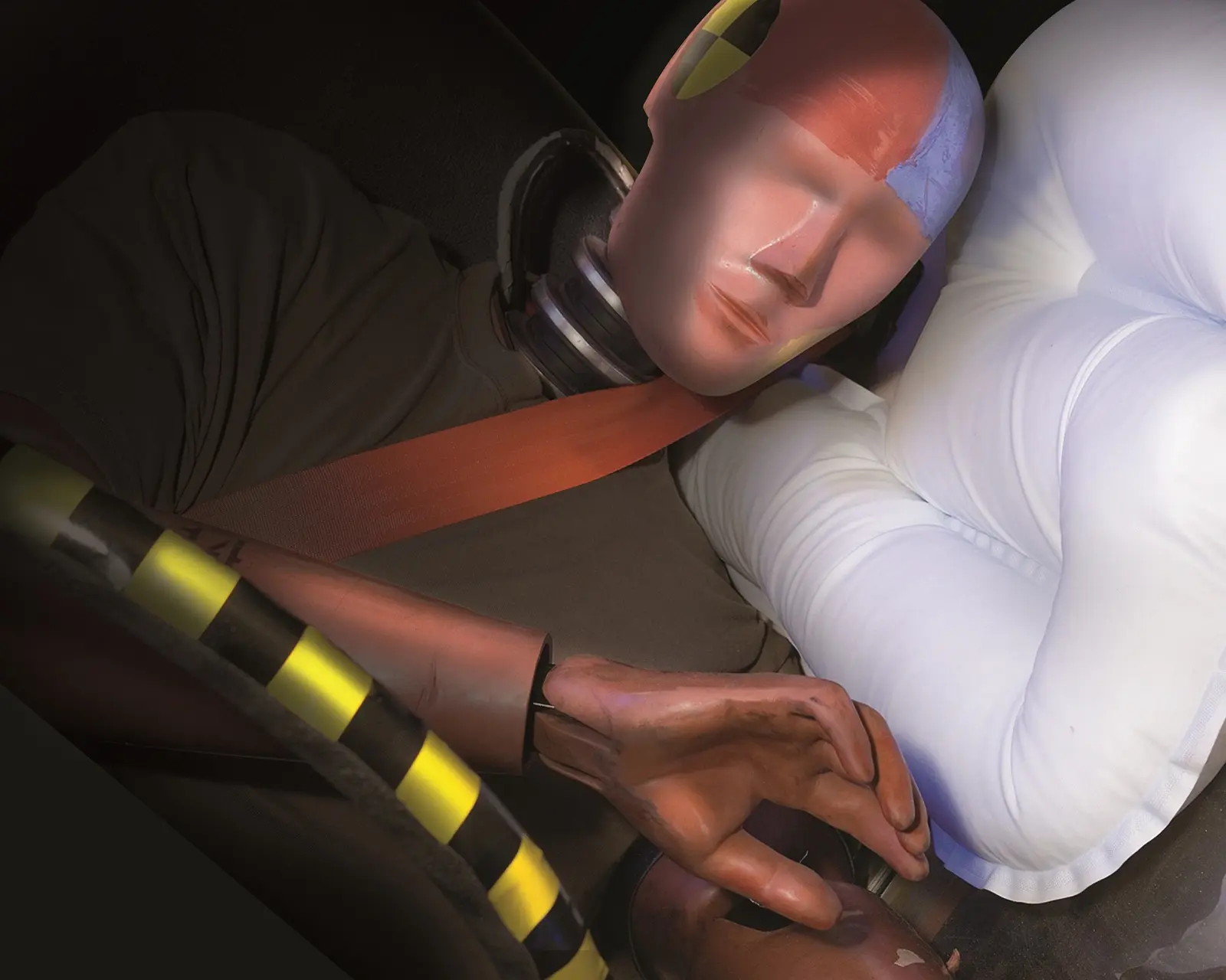 Crash-test dummy secured in a vehicle restraint during airbag deployment testing